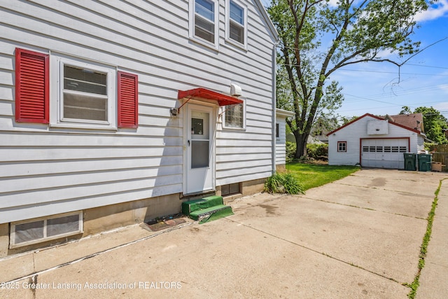 1615 Inverness Ave, Lansing, MI 48915 - view of side of home featuring entry steps, an outdoor structure, a garage, and driveway