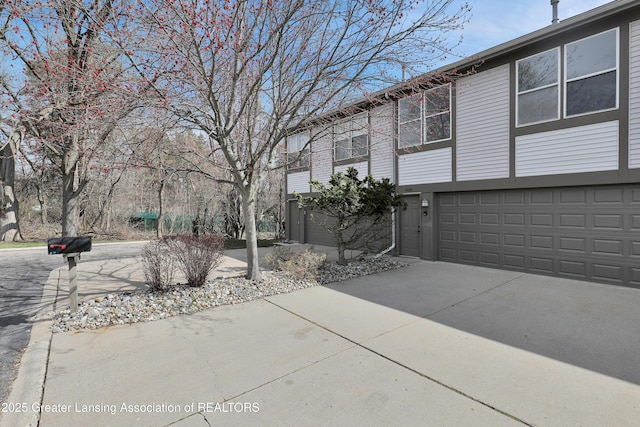 4003 Norfolk Ct, Lansing, MI 48910 - view of side of property featuring concrete driveway and an attached garage