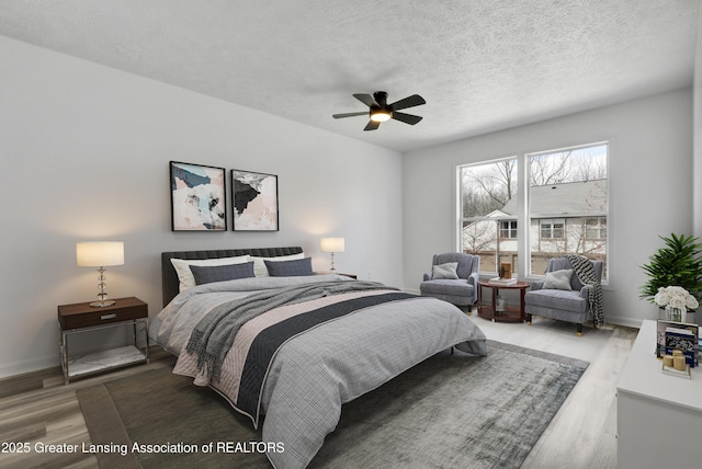 4003 Norfolk Ct, Lansing, MI 48910 - bedroom with wood finished floors, baseboards, a textured ceiling, and a ceiling fan