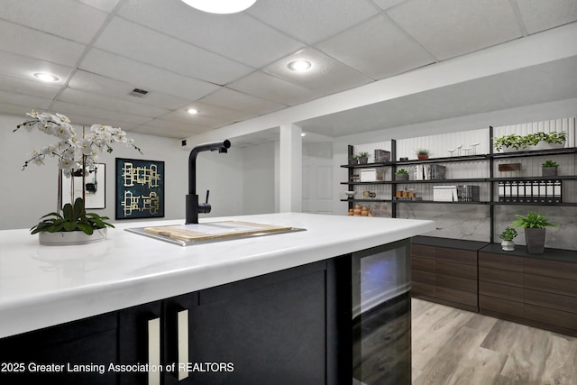 4003 Norfolk Ct, Lansing, MI 48910 - bar with light wood-style floors, a sink, a drop ceiling, and recessed lighting