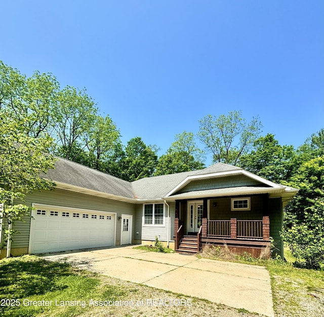 1826 Battle Creek Rd, Charlotte, MI 48813 - view of front of house with driveway, an attached garage, french doors, and a porch