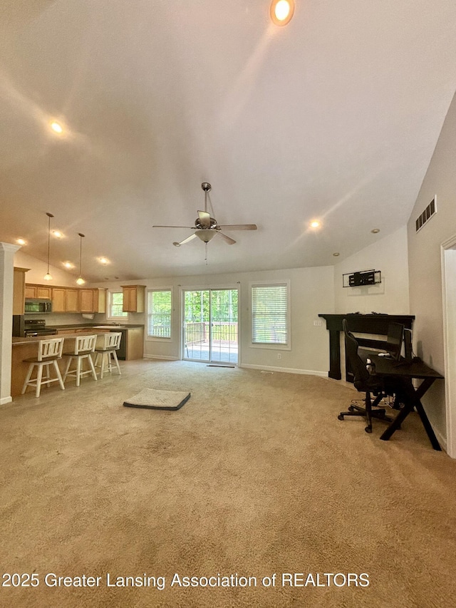 1826 Battle Creek Rd, Charlotte, MI 48813 - living area featuring plenty of natural light, light colored carpet, lofted ceiling, ceiling fan, and recessed lighting