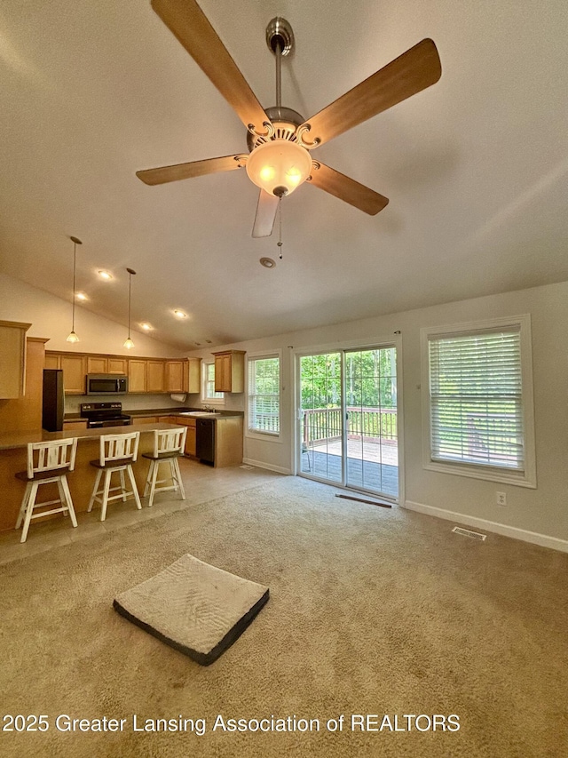 1826 Battle Creek Rd, Charlotte, MI 48813 - living area featuring lofted ceiling, light colored carpet, ceiling fan, and baseboards