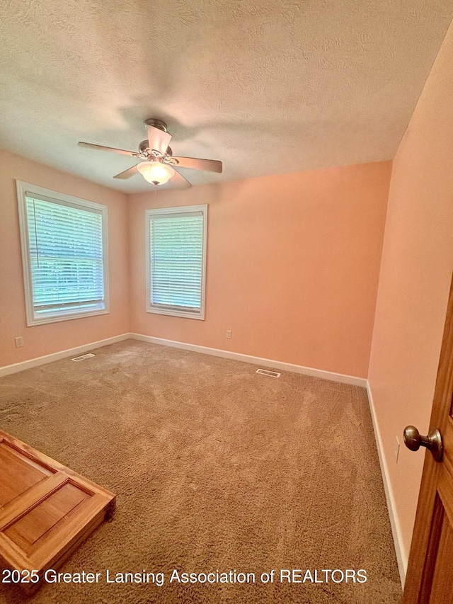 1826 Battle Creek Rd, Charlotte, MI 48813 - carpeted empty room featuring a textured ceiling, baseboards, and ceiling fan