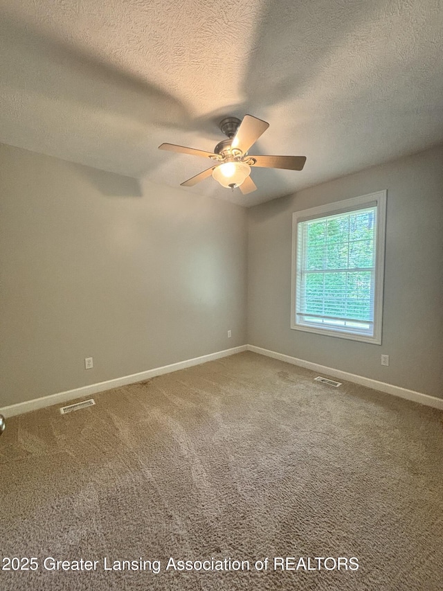 1826 Battle Creek Rd, Charlotte, MI 48813 - carpeted empty room featuring a textured ceiling, a ceiling fan, and baseboards