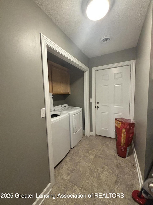 1826 Battle Creek Rd, Charlotte, MI 48813 - washroom featuring cabinet space, washing machine and dryer, baseboards, and a textured ceiling