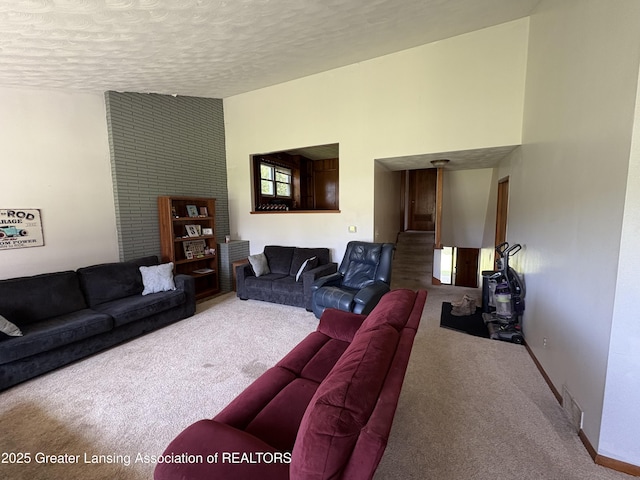 1064 W Shepherd St, Charlotte, MI 48813 - carpeted living area with a textured ceiling and baseboards