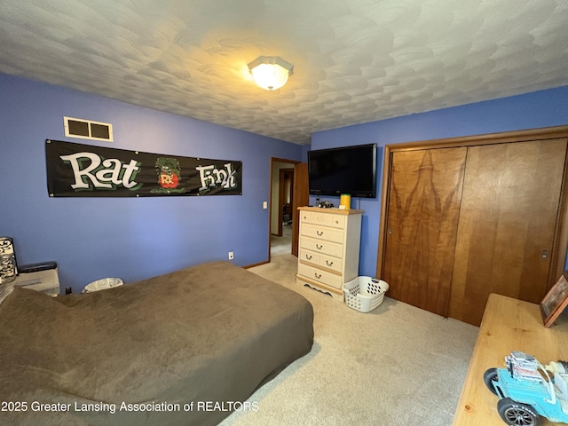 1064 W Shepherd St, Charlotte, MI 48813 - bedroom with carpet flooring, a closet, and a textured ceiling