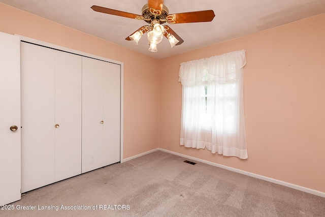 1005 Old Erin Way, Lansing, MI 48917 - unfurnished bedroom featuring carpet floors, baseboards, a closet, and ceiling fan