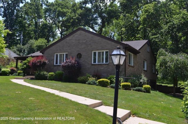 408 Whitehills Dr, East Lansing, MI 48823 - view of front facade with brick siding and a front yard