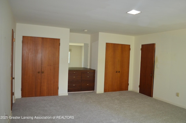 408 Whitehills Dr, East Lansing, MI 48823 - unfurnished bedroom with two closets and carpet