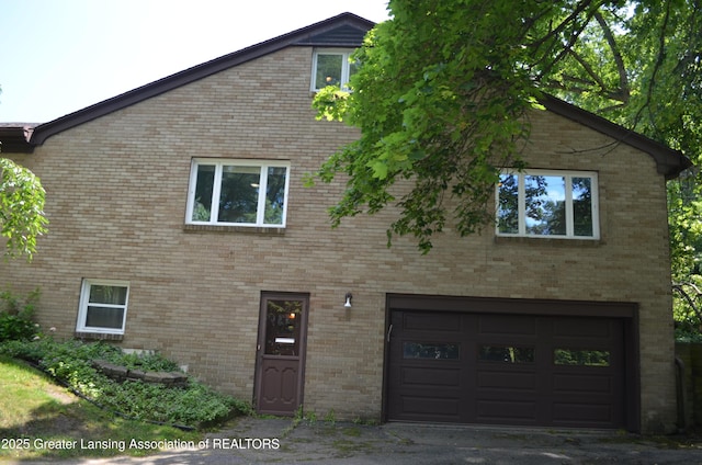 408 Whitehills Dr, East Lansing, MI 48823 - view of front of house with an attached garage and brick siding
