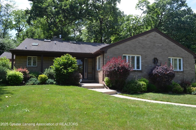408 Whitehills Dr, East Lansing, MI 48823 - ranch-style house with a front yard and brick siding