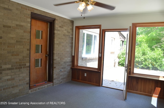 408 Whitehills Dr, East Lansing, MI 48823 - entryway with carpet floors, healthy amount of natural light, a ceiling fan, crown molding, and wood walls