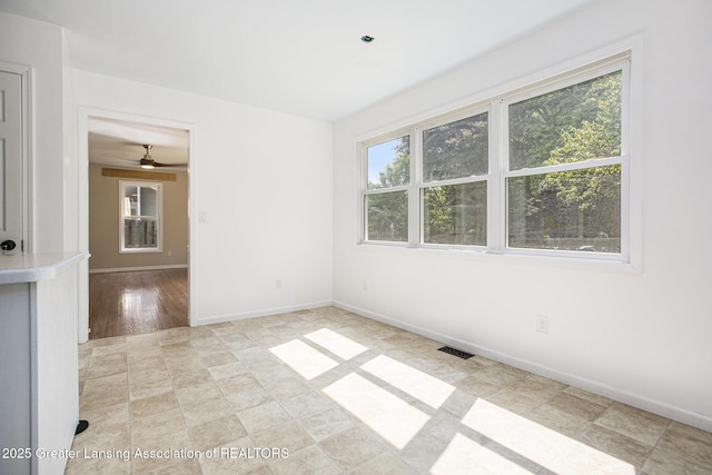 1321 Saint James Pl, Chelsea, MI 48118 - unfurnished room featuring plenty of natural light, baseboards, and ceiling fan