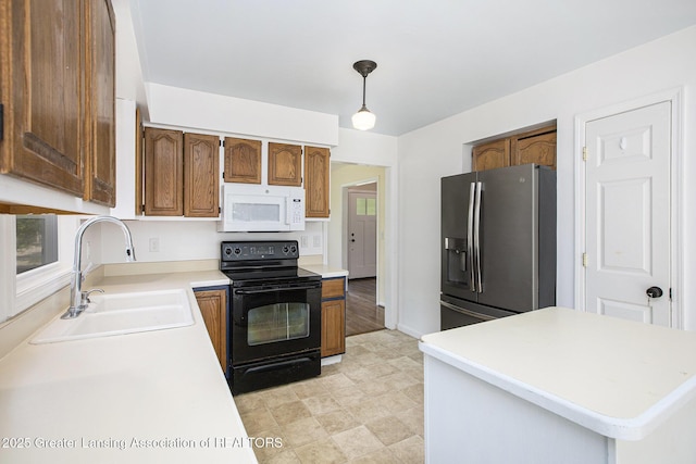 1321 Saint James Pl, Chelsea, MI 48118 - kitchen featuring white microwave, stainless steel fridge with ice dispenser, black range with electric stovetop, a sink, and light countertops