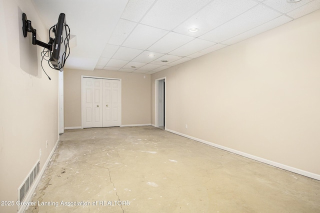 1321 Saint James Pl, Chelsea, MI 48118 - unfurnished bedroom with a closet, baseboards, concrete flooring, a paneled ceiling, and recessed lighting
