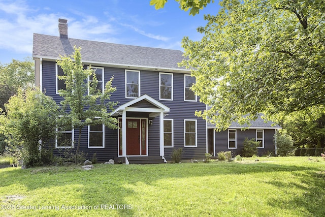 1321 Saint James Pl, Chelsea, MI 48118 - colonial-style house featuring a chimney, a front lawn, and roof with shingles