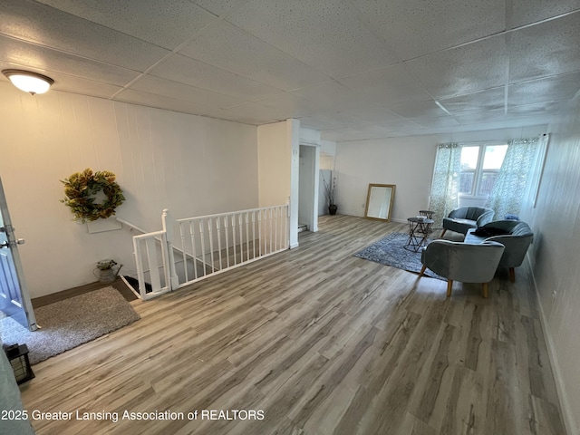 4208 Richmond St, Lansing, MI 48911 - living room featuring wood finished floors, a paneled ceiling, and baseboards