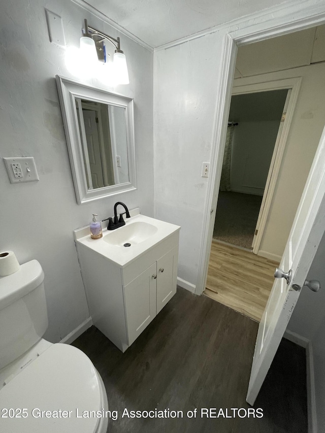 4208 Richmond St, Lansing, MI 48911 - half bath featuring toilet, vanity, wood finished floors, and baseboards