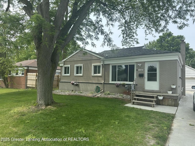 2107 Westbury Rd, Lansing, MI 48906 - back of house featuring entry steps, brick siding, a chimney, and a shingled roof