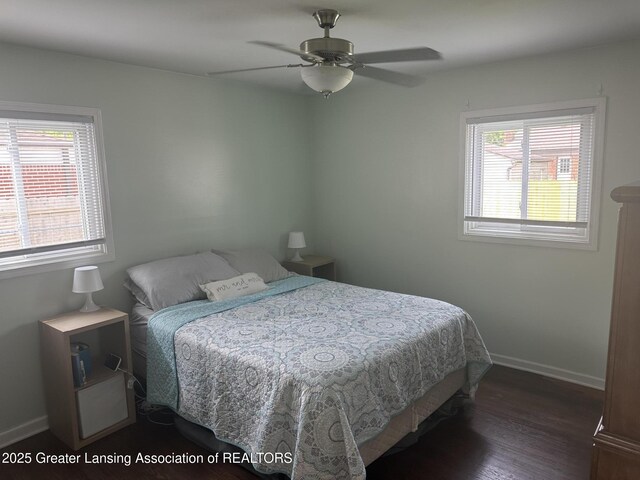 2107 Westbury Rd, Lansing, MI 48906 - bedroom with multiple windows, wood finished floors, baseboards, and a ceiling fan