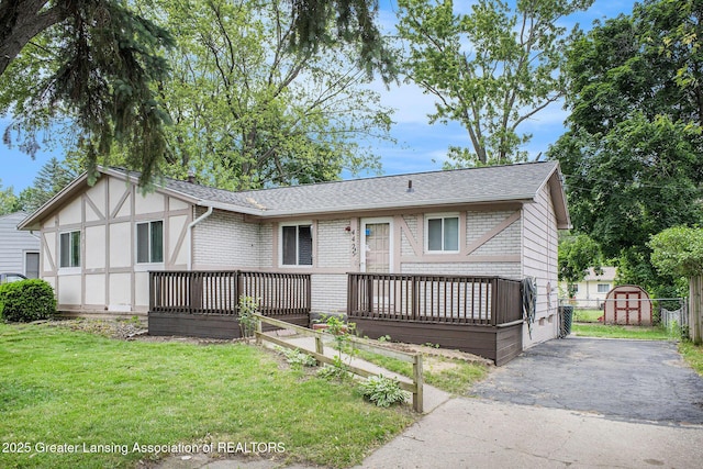 4425 Doncaster Ave, Holt, MI 48842 - view of front facade with a shingled roof and asphalt driveway
