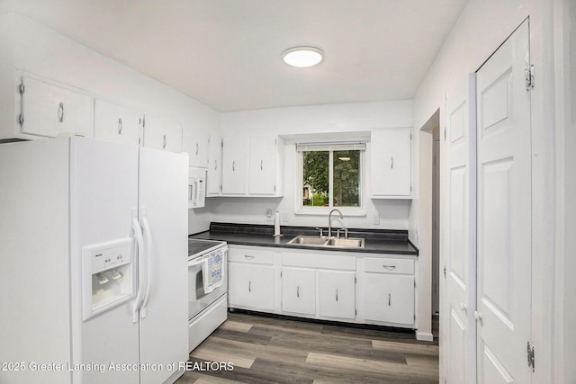 4425 Doncaster Ave, Holt, MI 48842 - kitchen with white appliances, a sink, dark countertops, and white cabinetry