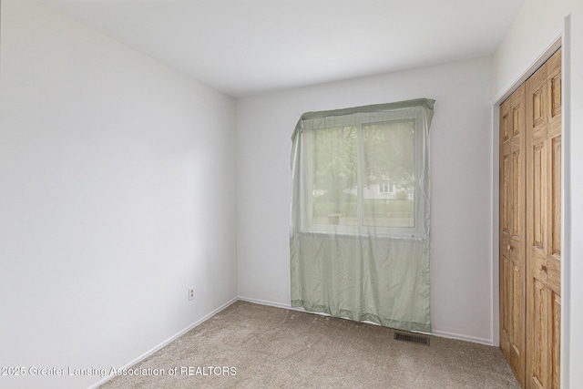 4425 Doncaster Ave, Holt, MI 48842 - spare room featuring light carpet and baseboards