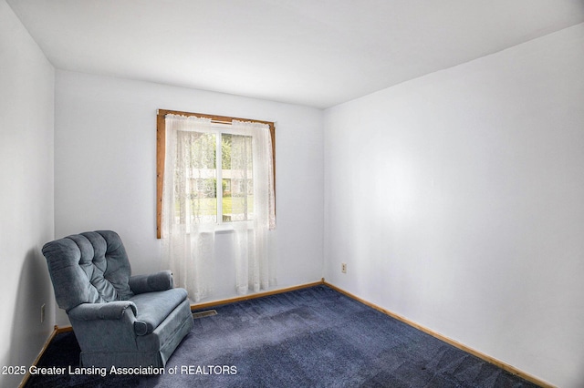 4425 Doncaster Ave, Holt, MI 48842 - living area with dark colored carpet and baseboards
