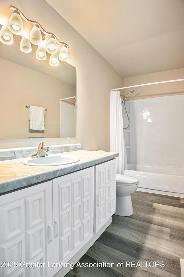 4425 Doncaster Ave, Holt, MI 48842 - full bath with wood finished floors, vanity, toilet, and shower / bath combination with curtain