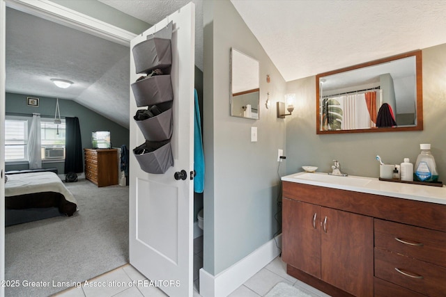 1928 Teel Ave, Lansing, MI 48910 - ensuite bathroom with a textured ceiling, lofted ceiling, vanity, baseboards, and cooling unit