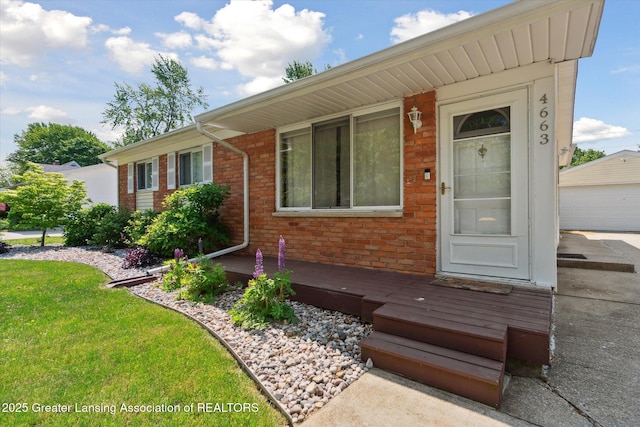 4663 Sycamore St, Holt, MI 48842 - view of front of property featuring brick siding, an outdoor structure, and a front yard