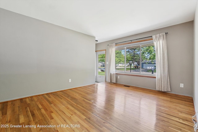 4663 Sycamore St, Holt, MI 48842 - empty room featuring wood finished floors and baseboards