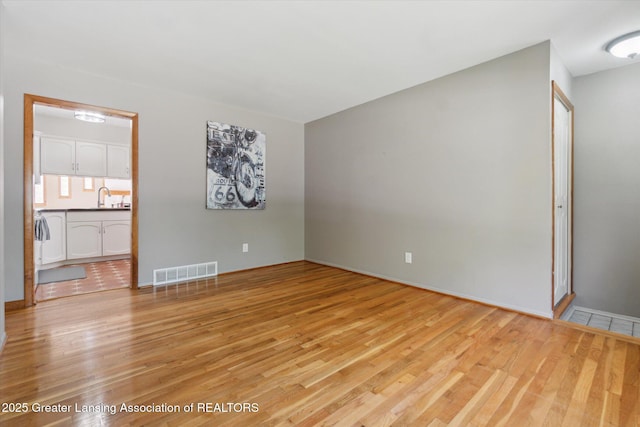 4663 Sycamore St, Holt, MI 48842 - empty room with light wood-type flooring and a sink