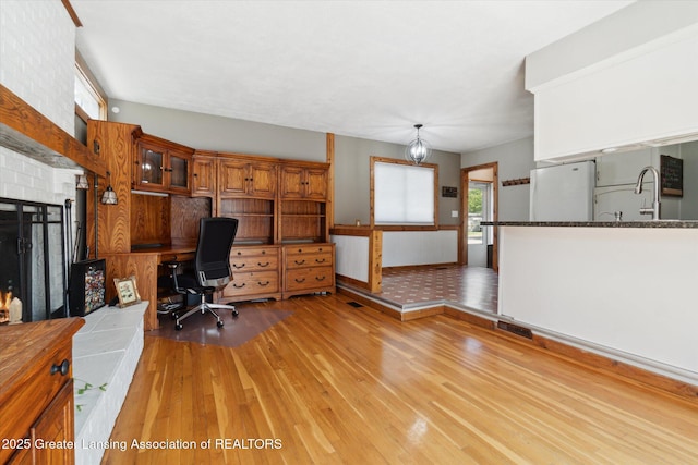 4663 Sycamore St, Holt, MI 48842 - office featuring light wood-type flooring, baseboards, and a sink