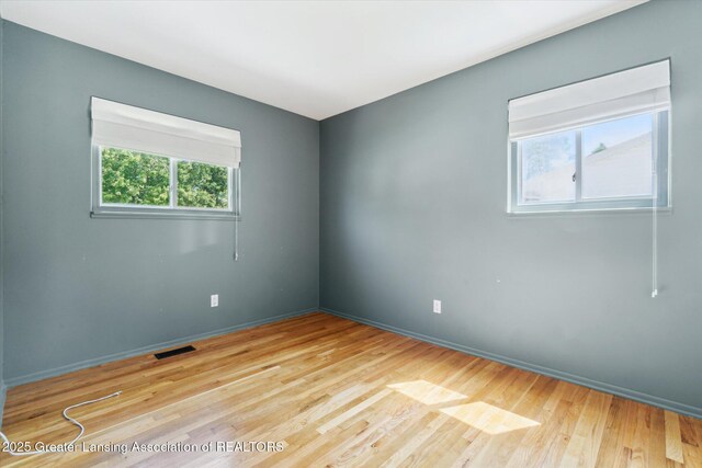 4663 Sycamore St, Holt, MI 48842 - unfurnished room with wood finished floors and baseboards