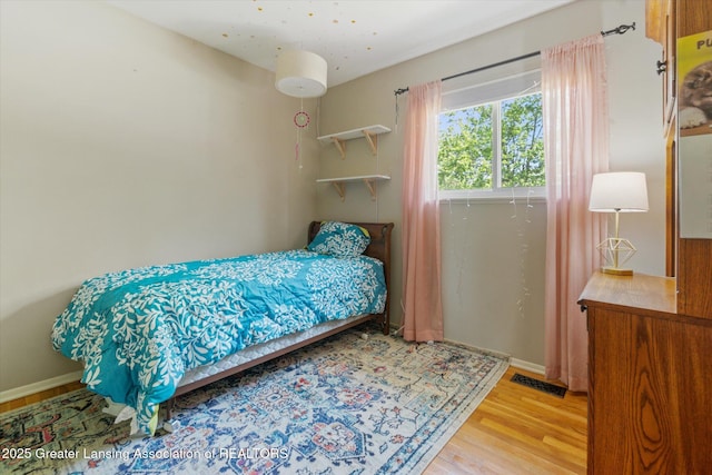 4663 Sycamore St, Holt, MI 48842 - bedroom with wood finished floors and baseboards