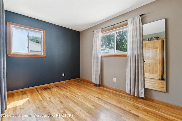 4663 Sycamore St, Holt, MI 48842 - spare room with wood finished floors and baseboards