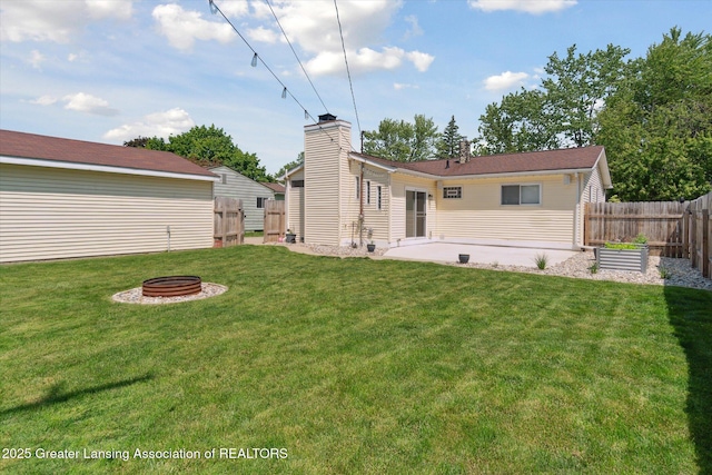4663 Sycamore St, Holt, MI 48842 - back of property with a fire pit and a patio