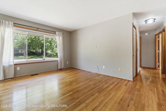 4663 Sycamore St, Holt, MI 48842 - empty room with light wood-style floors and baseboards