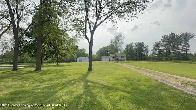9216 S Grove Rd, Dewitt, MI 48820 - view of green lawn with a garage and an outbuilding