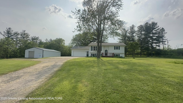 9216 S Grove Rd, Dewitt, MI 48820 - bi-level home featuring a detached garage, an outdoor structure, a front yard, and driveway