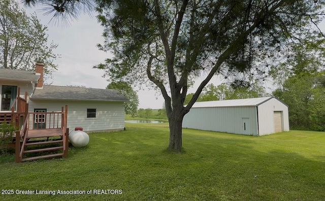 9216 S Grove Rd, Dewitt, MI 48820 - view of green lawn featuring a deck with water view and an outdoor structure
