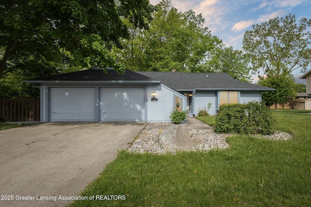 1098 Brookside Dr, Grand Ledge, MI 48837 - ranch-style home featuring a garage and a shingled roof