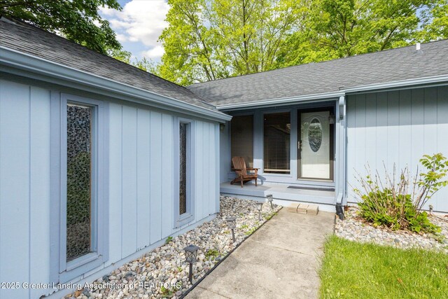 1098 Brookside Dr, Grand Ledge, MI 48837 - doorway to property with a shingled roof and covered porch