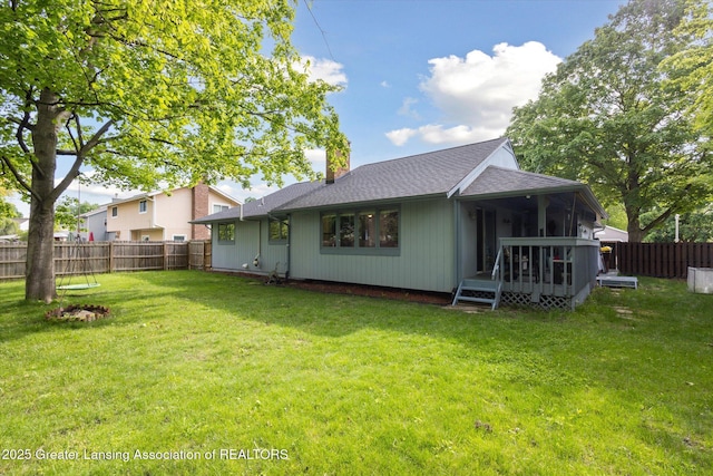 1098 Brookside Dr, Grand Ledge, MI 48837 - rear view of house with a deck, roof with shingles, and a chimney