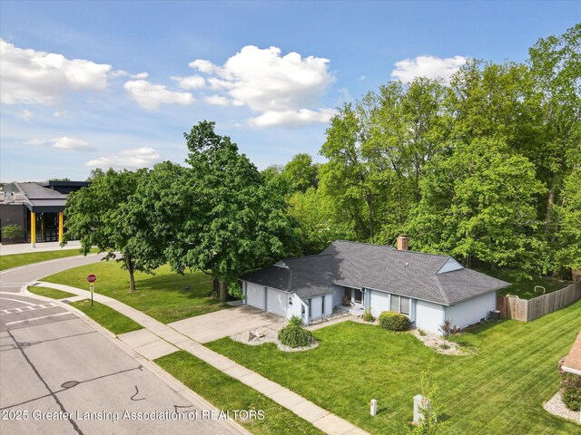 1098 Brookside Dr, Grand Ledge, MI 48837 - view of front of house featuring driveway, an attached garage, roof with shingles, and a chimney