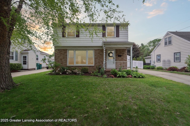1023 N Hayford Ave, Lansing, MI 48912 - view of front of house with brick siding, a front lawn, and covered porch