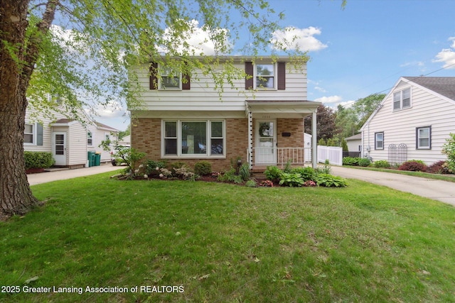 1023 N Hayford Ave, Lansing, MI 48912 - view of front of house with a front lawn, brick siding, and a porch